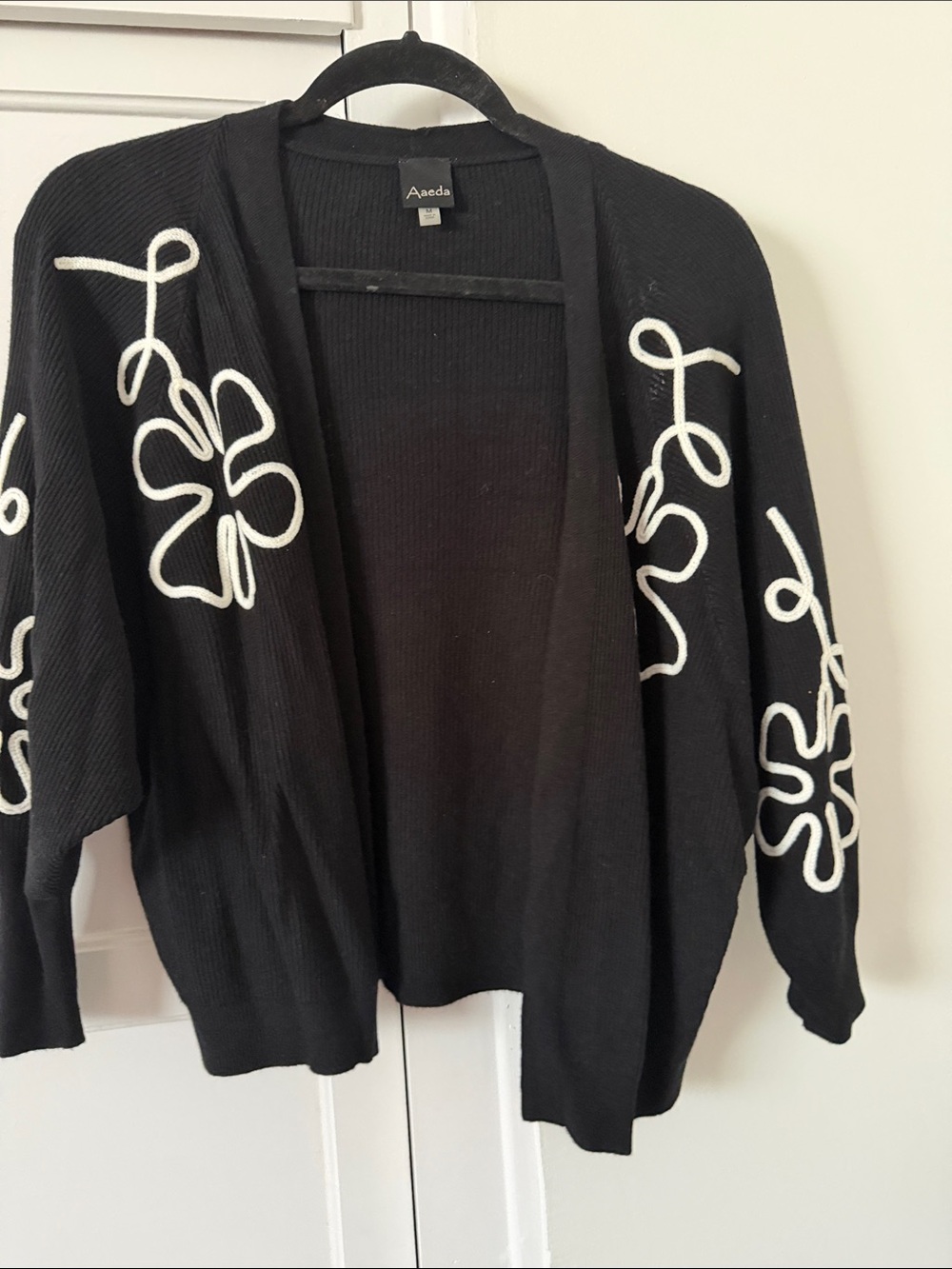 Black Open-Front Cardigan with White Floral Rope Detail